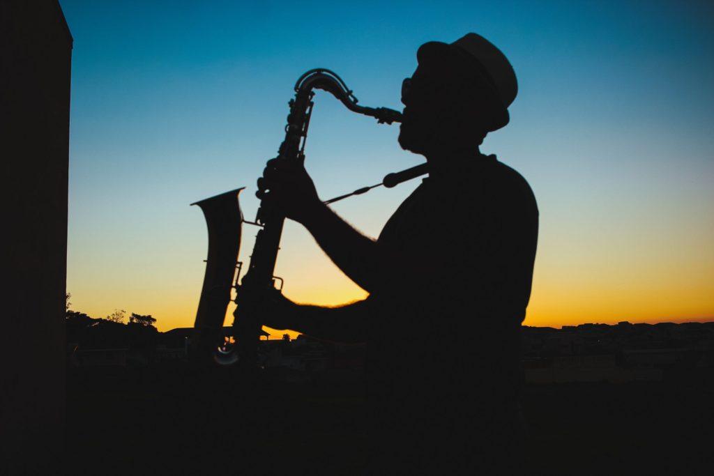 Man playing saxaphone. Represents improvisational nature of design.